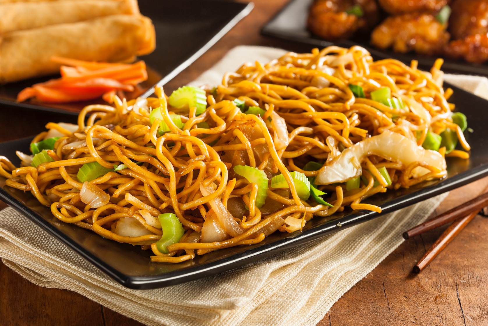 plate of fried chow mein with vegetables