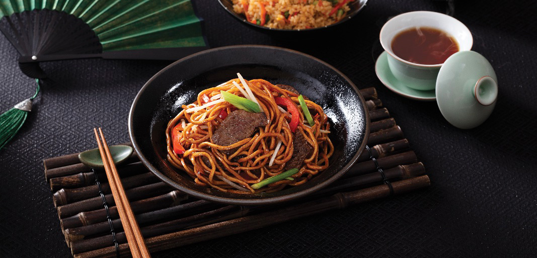 bowl of asian noodles with steak and vegetables