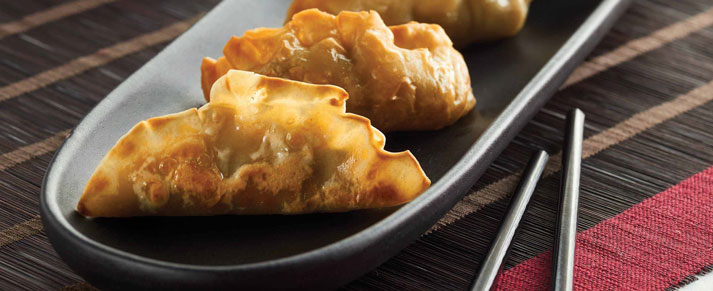 Plate of foodservice Amoy Asian Shrimp Potstickers in a restaurant setting