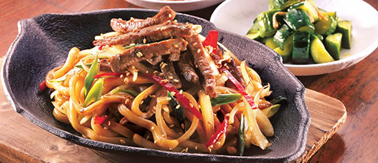 Plate of foodservice Amoy Asian Korean Style Spicy Stir-fry Udon in a restaurant setting